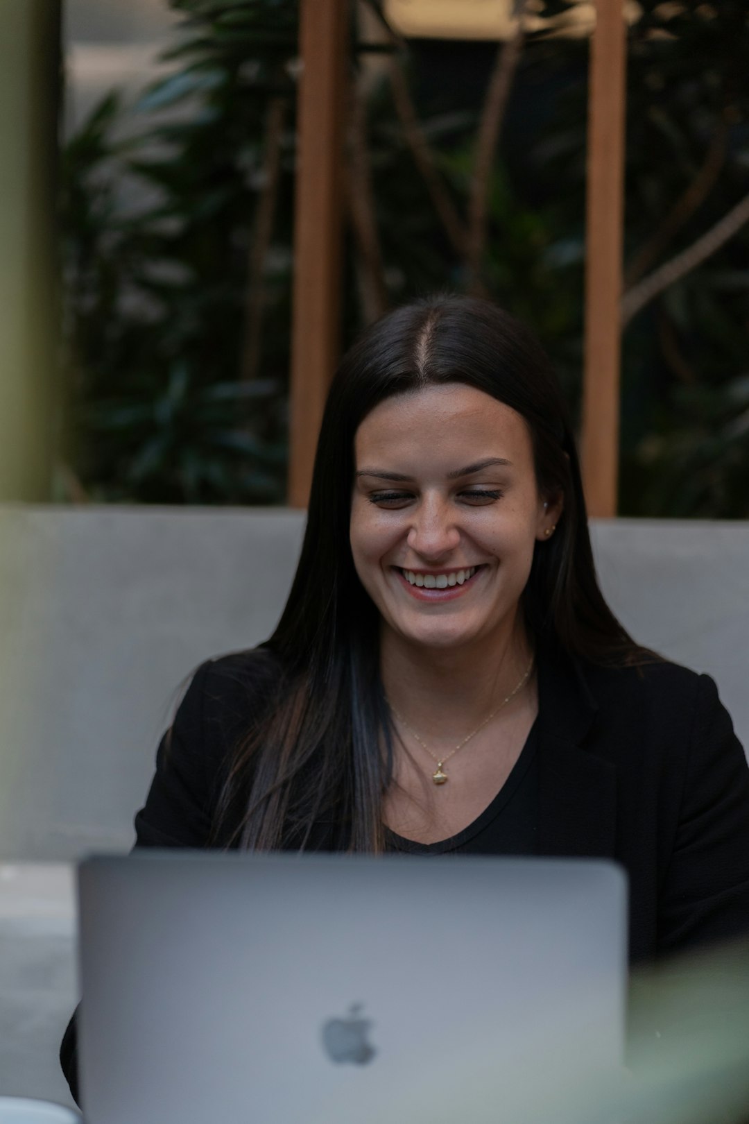 A woman sitting in front of a laptop computer